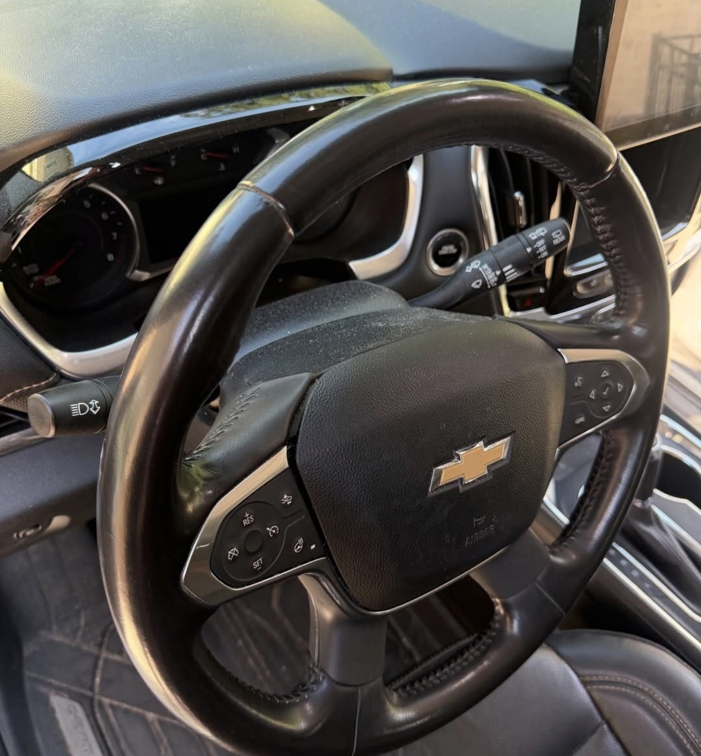 Chevrolet steering wheel and driver area before detailing