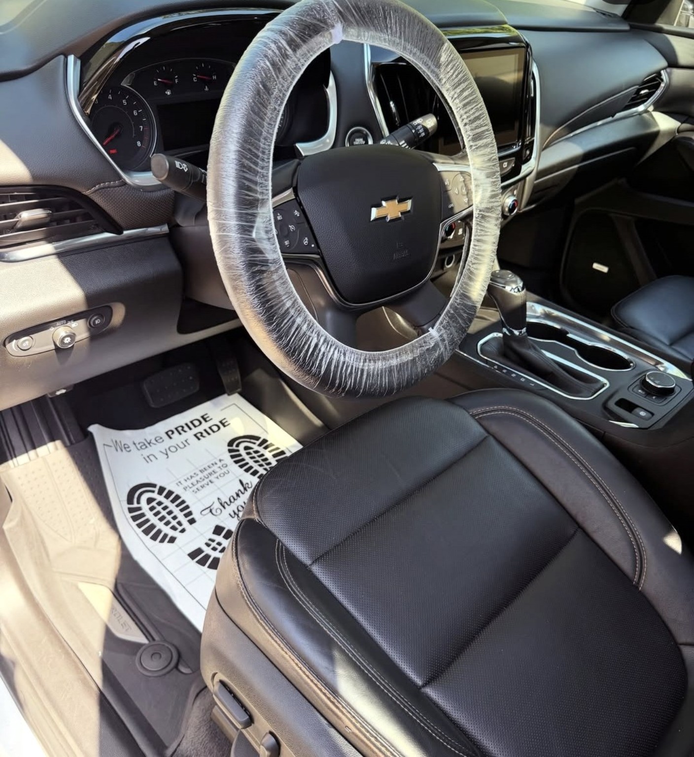 Chevrolet driver area after cleaning, with steering wheel wrapped for protection