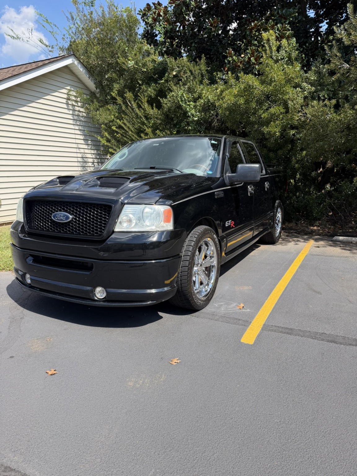 Black Ford F-150 after detailing with clean paint and clear headlights