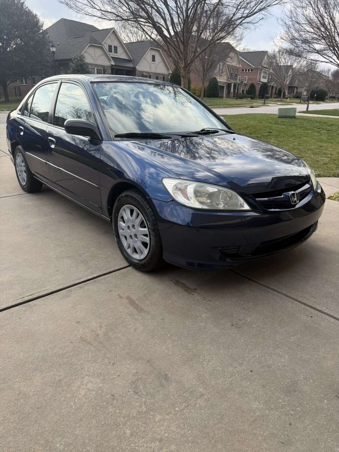Blue Honda Civic after detailing, with clean paint, wheels, and clearer headlights