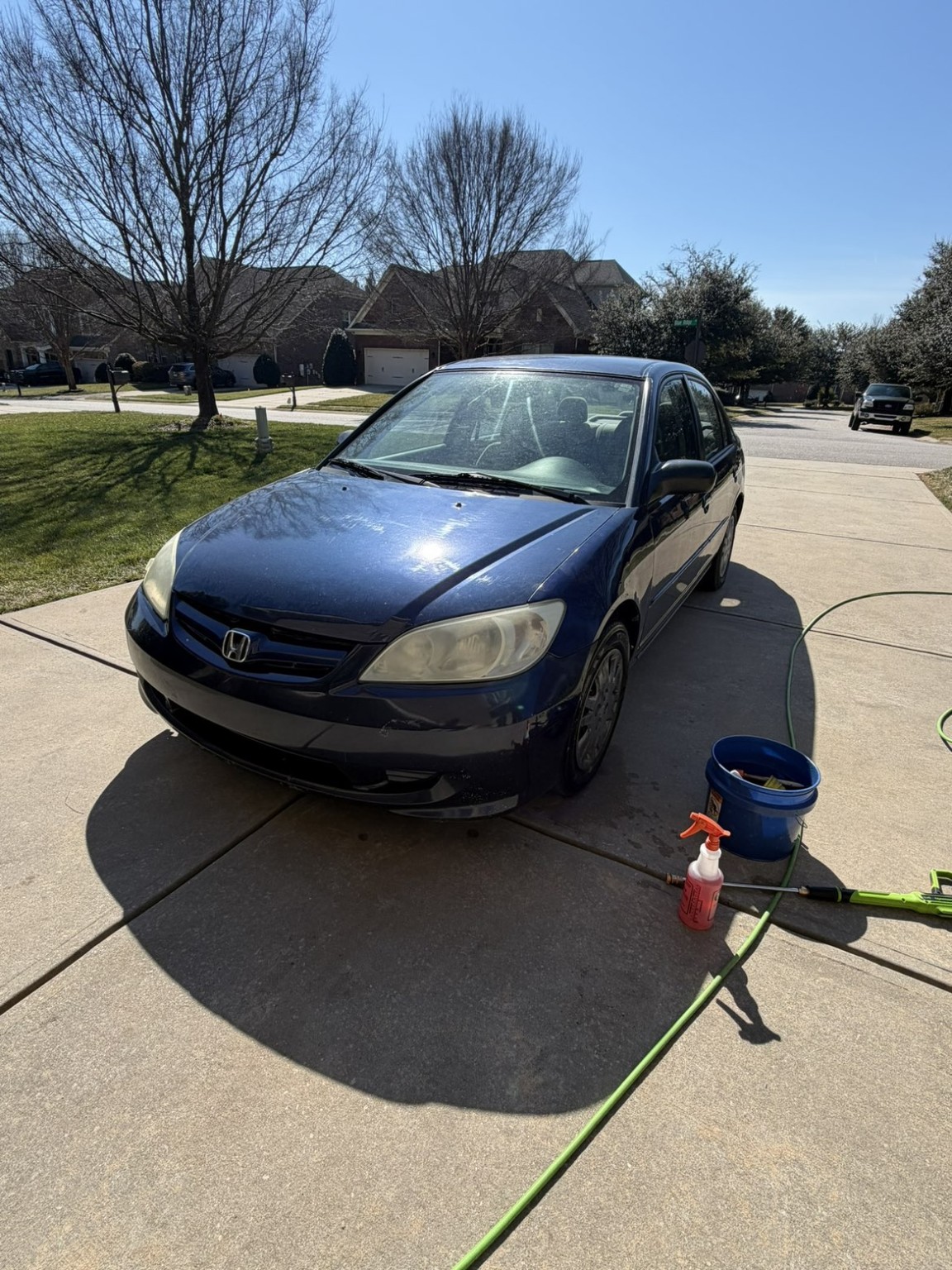 Blue Honda Civic before detailing, with dull paint and cloudy headlights