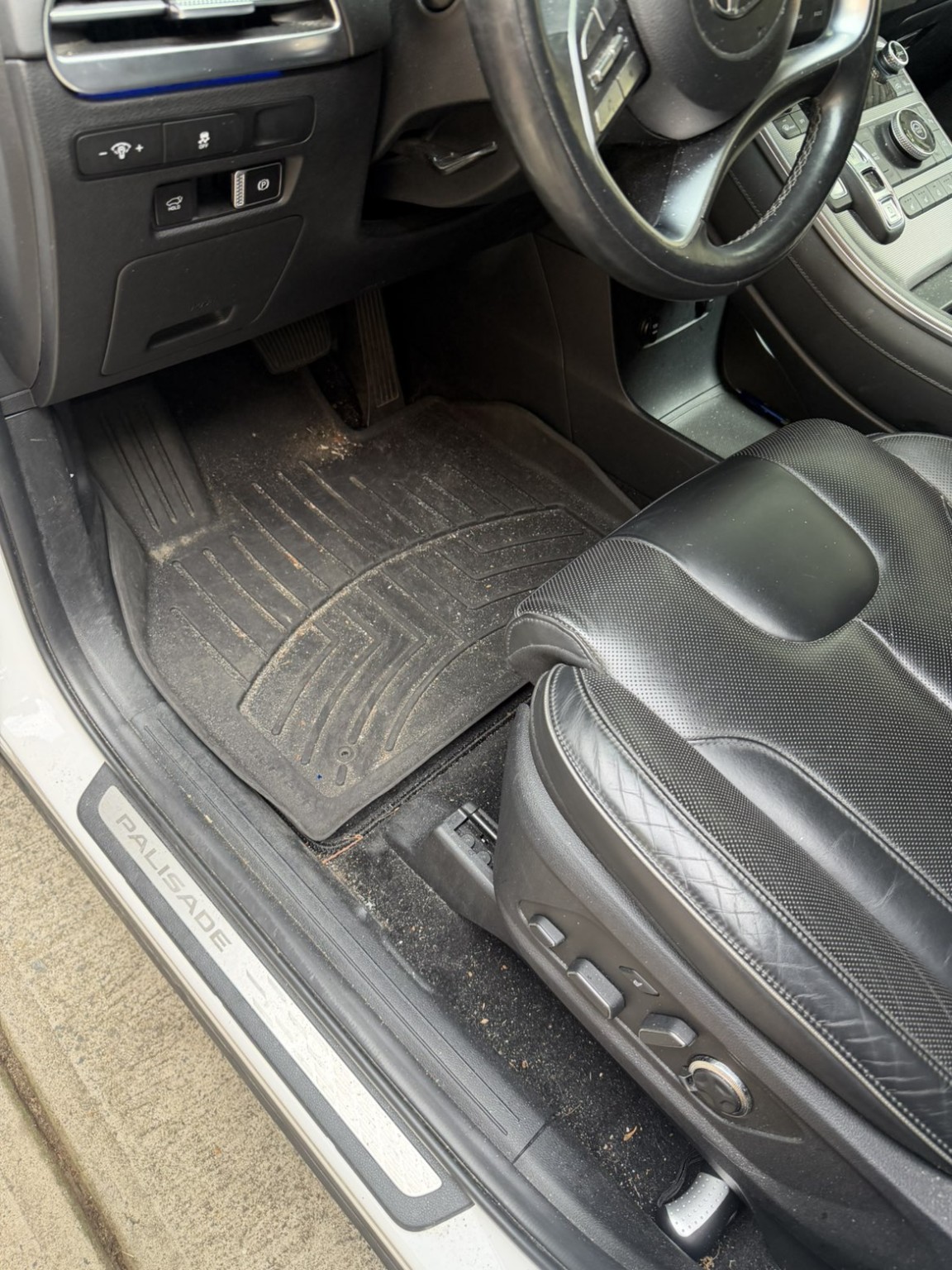 Hyundai Palisade driver floor mat before cleaning, with dirt and debris