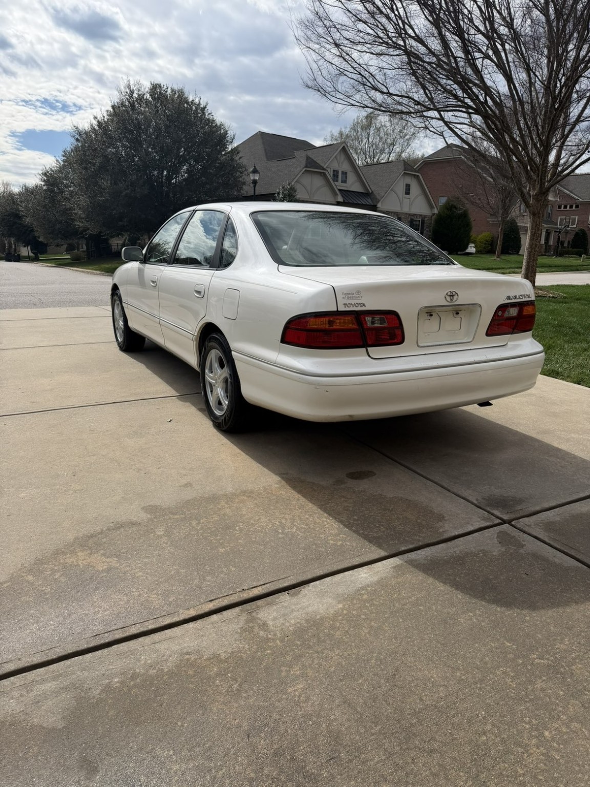 White Toyota Avalon after detailing, with a clean rear and glossy finish